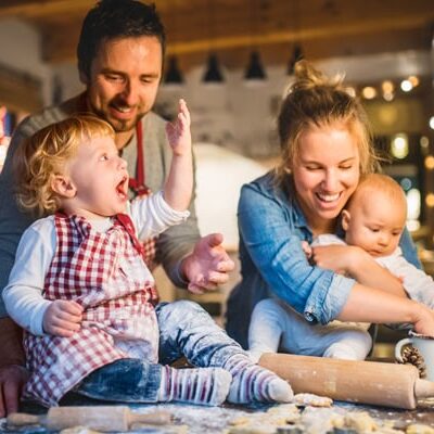 Young family making cookies at home.